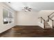 Spacious living room with large windows, hardwood floors, and staircase at 1067 Brittania Rd, Stone Mountain, GA 30083