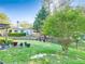 Expansive backyard with lush lawn, mature trees, a pergola and a black metal fence at 2486 Ridgelake Dr, Villa Rica, GA 30180