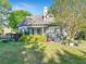 Beautiful backyard featuring green grass, lush landscaping, a covered patio, and outdoor seating area at 2486 Ridgelake Dr, Villa Rica, GA 30180
