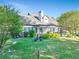 Lush backyard with a manicured lawn, mature trees, and a charming patio area, ideal for outdoor entertaining at 2486 Ridgelake Dr, Villa Rica, GA 30180