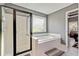 Bathroom featuring a separate glass-enclosed shower and luxurious soaking tub at 2486 Ridgelake Dr, Villa Rica, GA 30180
