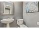 Charming half bathroom featuring a pedestal sink and decorative mirror at 2486 Ridgelake Dr, Villa Rica, GA 30180