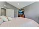 Bedroom featuring a cozy bed near a window, complete with a TV set on a dresser and closet doors at 2486 Ridgelake Dr, Villa Rica, GA 30180