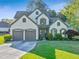 Charming two-story home with manicured lawn, two-car garage, and inviting front entrance at 2486 Ridgelake Dr, Villa Rica, GA 30180