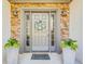 Inviting front door framed by decorative stone, planters, and stylish lighting at 2486 Ridgelake Dr, Villa Rica, GA 30180