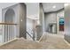 Hallway featuring neutral-toned walls, carpeted flooring, and staircase leading to the lower level at 2486 Ridgelake Dr, Villa Rica, GA 30180