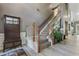 Elegant staircase with wood railings and a neutral-toned runner, complemented by stylish decor at 2486 Ridgelake Dr, Villa Rica, GA 30180