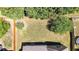 Aerial view of the fenced back yard with well-maintained lawn, landscaping and privacy trees at 28 Summer Nw Pl, Cartersville, GA 30121