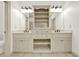Bathroom showcasing dual vanities with storage, decorative lighting, and a linen cabinet at 28 Summer Nw Pl, Cartersville, GA 30121
