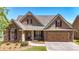 Charming home featuring stone accents, a two-car garage, well-manicured lawn, and a welcoming entrance at 28 Summer Nw Pl, Cartersville, GA 30121