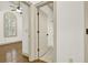 Hallway leading to a bathroom, featuring hardwood floors, fresh paint, and a vaulted ceiling at 28 Summer Nw Pl, Cartersville, GA 30121