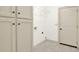Bright laundry room with overhead cabinets and tile flooring at 28 Summer Nw Pl, Cartersville, GA 30121