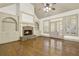 Living room with stone fireplace, vaulted ceilings, hardwood floors, and built in shelving at 28 Summer Nw Pl, Cartersville, GA 30121