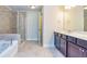 Bathroom featuring a walk-in shower, bathtub, and double sink vanity with marble countertops at 2808 White Oak Ln, Decatur, GA 30032