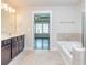 Lovely bathroom offering soaking tub, tiled floors, and an open layout to the bedroom at 2808 White Oak Ln, Decatur, GA 30032
