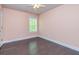 A charming bedroom with dark wood floors, a ceiling fan, and a window with natural light at 2808 White Oak Ln, Decatur, GA 30032