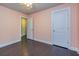 A lovely bedroom features light pink walls, dark wood floors, and two white doors at 2808 White Oak Ln, Decatur, GA 30032