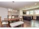 Open-concept dining and kitchen area, featuring hardwood floors, kitchen island, and stainless steel appliances at 2808 White Oak Ln, Decatur, GA 30032