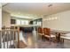View of kitchen featuring stainless appliances, dark cabinetry, pendant lights, island and hardwood floors at 2808 White Oak Ln, Decatur, GA 30032