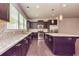 Bright kitchen with stainless steel appliances, island, granite countertops, and mosaic backsplash at 2808 White Oak Ln, Decatur, GA 30032