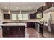 Spacious kitchen featuring dark wood cabinets, stainless steel appliances, and a granite countertop island at 2808 White Oak Ln, Decatur, GA 30032