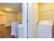 Convenient upstairs laundry area with a modern washing machine and storage shelving at 2808 White Oak Ln, Decatur, GA 30032