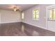 Bright and airy living area with hardwood floors, a ceiling fan, and large windows at 2808 White Oak Ln, Decatur, GA 30032