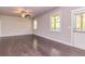 Bright living room featuring hardwood floors, a ceiling fan, and a door that leads to the outdoors at 2808 White Oak Ln, Decatur, GA 30032