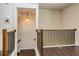 Staircase featuring wooden banisters, hardwood floors, a pendant light and access to the upper level at 2808 White Oak Ln, Decatur, GA 30032