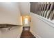 Well-lit staircase featuring modern railings and a view of the entry door at 2808 White Oak Ln, Decatur, GA 30032