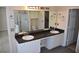 Bathroom with double sinks, a large mirror, vanity with white cabinets, and views into tub area at 5229 Pinnacle Pointe Ct, Norcross, GA 30071