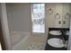 Bathroom with double sinks, tile floors, bath and shower combo with natural light from a window at 5229 Pinnacle Pointe Ct, Norcross, GA 30071