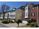 View of townhomes, some with brick and others with siding, all with attached garages at 5229 Pinnacle Pointe Ct, Norcross, GA 30071