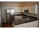 A spacious kitchen features stainless steel appliances, dark countertops and white cabinets at 5229 Pinnacle Pointe Ct, Norcross, GA 30071
