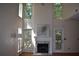 Bright living room showcases hardwood floors, fireplace, high ceilings, and a fan at 5229 Pinnacle Pointe Ct, Norcross, GA 30071