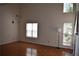 A bright and airy living room is accented by wood floors and a large window at 5229 Pinnacle Pointe Ct, Norcross, GA 30071