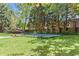 Landscaped backyard featuring an in-ground pool, wooden fencing, and a long wooden bench at 1047 Winding Branch Ct, Atlanta, GA 30338