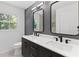 Modern bathroom with double vanity, rectangular mirrors and great natural light at 1047 Winding Branch Ct, Atlanta, GA 30338