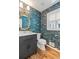 Beautiful bathroom features a vanity with modern fixtures and stylish wallpaper at 1047 Winding Branch Ct, Atlanta, GA 30338