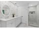 Bright bathroom featuring double vanity, decorative wallpaper and seamless glass walk-in shower at 1047 Winding Branch Ct, Atlanta, GA 30338