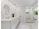 Bright bathroom featuring double vanity, decorative wallpaper, freestanding tub and walk-in shower at 1047 Winding Branch Ct, Atlanta, GA 30338
