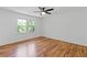 Bright bedroom featuring hardwood floors, ceiling fan and natural light at 1047 Winding Branch Ct, Atlanta, GA 30338
