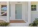 Close up of a light blue front door with brick pavers and white brick accents at 1047 Winding Branch Ct, Atlanta, GA 30338