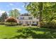 Charming two-story traditional home with manicured lawn, mature trees, and light blue shutters at 1047 Winding Branch Ct, Atlanta, GA 30338