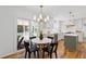 Eat-in kitchen featuring stainless steel appliances, white cabinets and a dining area with modern lighting at 1047 Winding Branch Ct, Atlanta, GA 30338