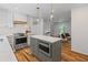 Modern kitchen with stainless steel appliances, a center island, and hardwood floors at 1047 Winding Branch Ct, Atlanta, GA 30338
