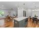Modern kitchen with a center island, stainless steel appliances, and hardwood floors open to the living room at 1047 Winding Branch Ct, Atlanta, GA 30338