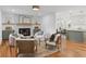 Open-concept living room with fireplace flows into a modern kitchen and dining area, perfect for entertaining at 1047 Winding Branch Ct, Atlanta, GA 30338