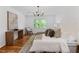 Bright and airy main bedroom features hardwood floors, a large window, and neutral decor at 1047 Winding Branch Ct, Atlanta, GA 30338