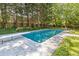 Sparkling in-ground swimming pool with diving board surrounded by a concrete pool deck and landscaping at 1047 Winding Branch Ct, Atlanta, GA 30338